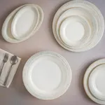 Bonna Galata round flat plate in cream and pale grey glaze, viewed from above with matching oval and smaller plates.