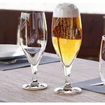 Stolzle Iserlohn Beer 400ml glasses in use, one filled with golden lager and the other empty, revealing their clear tulip-shaped bowls.