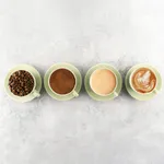Pistachio Long Black Cup 180ml in use, four matte green ceramic cups holding beans, grounds, espresso, and latte