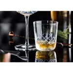 Utopia Raffles Diamond Nick & Nora glass in use with an amber cocktail, featuring a cut-crystal diamond lattice pattern on the lower bowl.