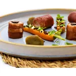 Urban Loft Azure Blue Serve Platter 320mm close-up in use with appetizers, featuring a textured golden-brown rim and light blue-grey glaze.