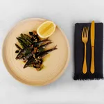 Tablekraft Urban Loft Sandstone Sauce Dish in use, top-down view of sandstone ceramic plate with concentric ridges holding fish and asparagus.