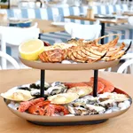 Chef Inox 2-tier seafood stand in use, holding lobster and shellfish on ice in a restaurant setting.