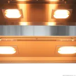 Close-up of the Benchstar Commercial Food Warmer Fw4l interior showing four illuminated oval lamps in recessed frames on brushed stainless-steel panels.
