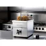 Apuro Induction Fryer in use with a basket of fries, featuring a stainless steel body and black drain valve.