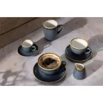 Olympia Kiln Ocean Cup lifestyle shot showing four grey ceramic cups with gold rims and a creamer on a stone surface