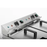 Close-up of the Apuro Double Induction Fryer control panel with two black rotary dials, green switches, and red and blue indicator lights.