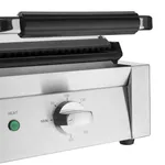 Close-up of the Apuro Bistro Contact Grill front panel showing the green heat light and black temperature dial on brushed stainless steel.