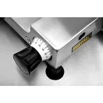 Close-up of the Apuro Meat Slicer's lower corner, showing the black thickness knob, white dial, and yellow BUFFALO badge on the brushed steel body.