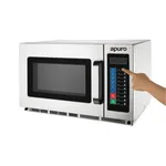 Apuro Commercial Microwave in stainless steel, three-quarter view with a hand pressing the keypad buttons.