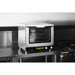 Apuro Convection Oven with Steam in use on a counter, showing the stainless steel body, glass door, and black control panel with green logo.