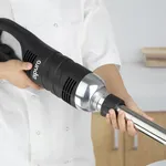 Apuro stick blender in use, close-up of black motor housing with white logo and stainless steel shaft