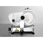 Apuro Meat Slicer - 250mm side view showing silver ribbed housing, black adjustment knob, and clear acrylic food pusher on the feed tray.