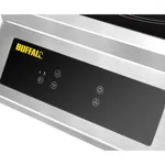Close-up of the Apuro Heavy Duty Induction Hob's brushed stainless steel front panel with a black glass touch-control strip and yellow BUFFALO logo.