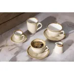 Olympia Kiln Sandstone Espresso Cup in use with crema, part of a cream ceramic set with gold rims on a marble surface