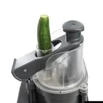 Dito Sama Prep4you Vegetable Slicer in use, close-up of cucumber in grey feed chute with clear safety guard and spiral blade.