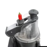 Close-up of the Dito Sama Prep4you Vegetable Slicer with a red chili in the feed tube, showing the dark grey handle and clear safety guard.