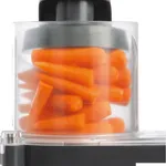 Dito Sama Prep4you Vegetable Slicer close-up showing the transparent feed container filled with whole orange carrots under a black pusher cap.