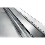 Close-up of the Tecnodom TMDR-0920B deli display showing the brushed stainless-steel front edge and top ventilation grille with vertical slats.