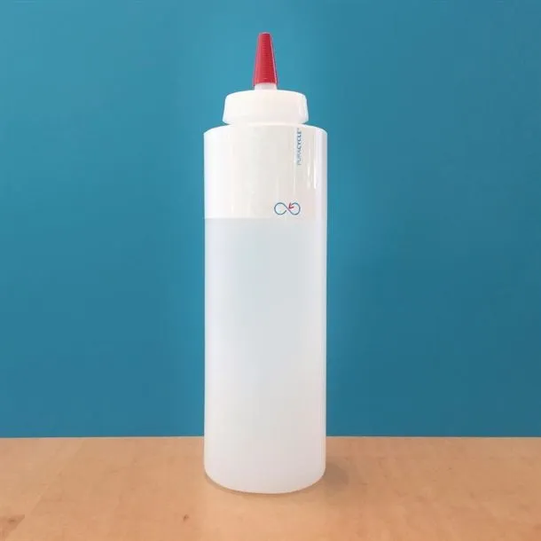 Puracycle blank bottle label applied to a white squeeze bottle with a red nozzle, showing the product in use.