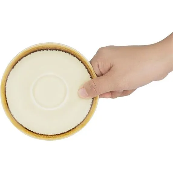 Olympia Kiln Sandstone Saucer underside close-up showing matte cream base and speckled brown rim