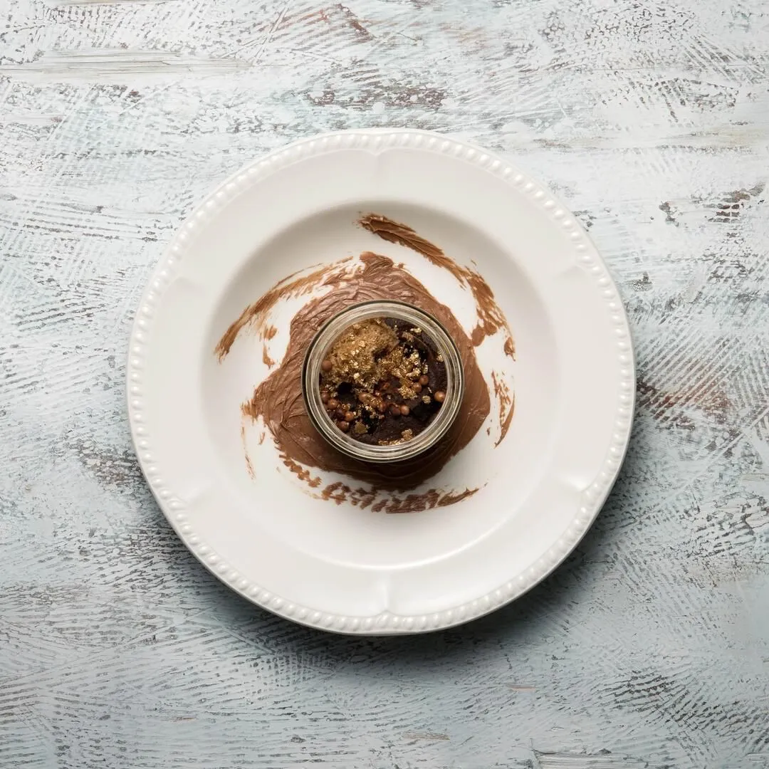 Churchill round wide rim pasta plate in use, top-down view with a chocolate dessert in the deep central well