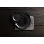 Overhead view of two matte black Dudson Round Coupe Plates with speckled finish and dark berries