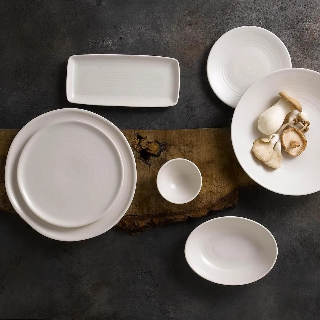 Overhead view of the Dudson Round Coupe Plate-162mm Ø, a white matte ceramic dish with a wide rim and concentric texture.
