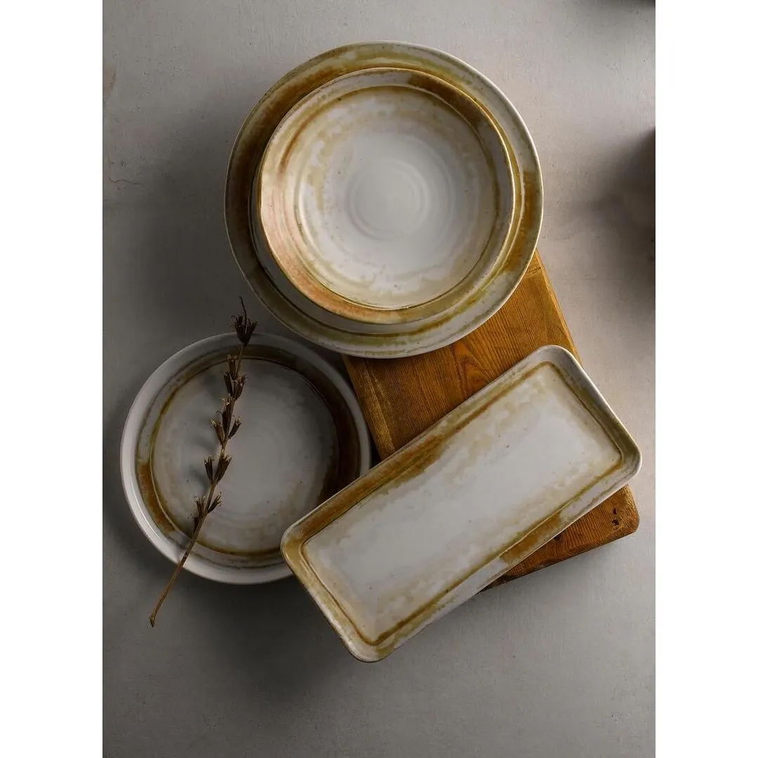 Dudson Rect Coupe Plate in an overhead lifestyle shot with round plates, featuring a white centre and mottled brown rim on a wooden board.