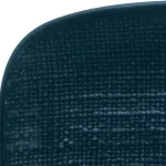 Close-up of the corner of the Luzerne rectangular share plate, showing the dark woven-fibre texture and rounded edge.