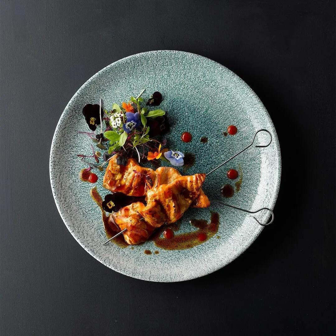 Churchill oblong chefs plate in pale blue-grey glaze, top-down view with plated salmon, edible flowers, and red sauce accents.
