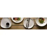 Churchill Round Coupe Bowl in use, four white matte ceramic bowls holding salads, sauce, and cutlery on a wooden table