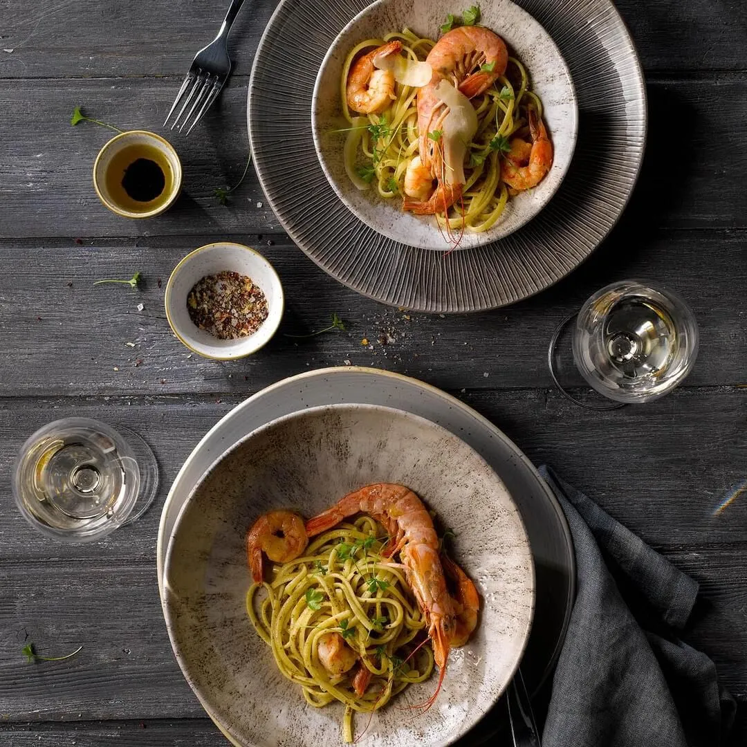 Churchill Round Coupe Plate in use, holding pasta and prawns on a dark wooden table