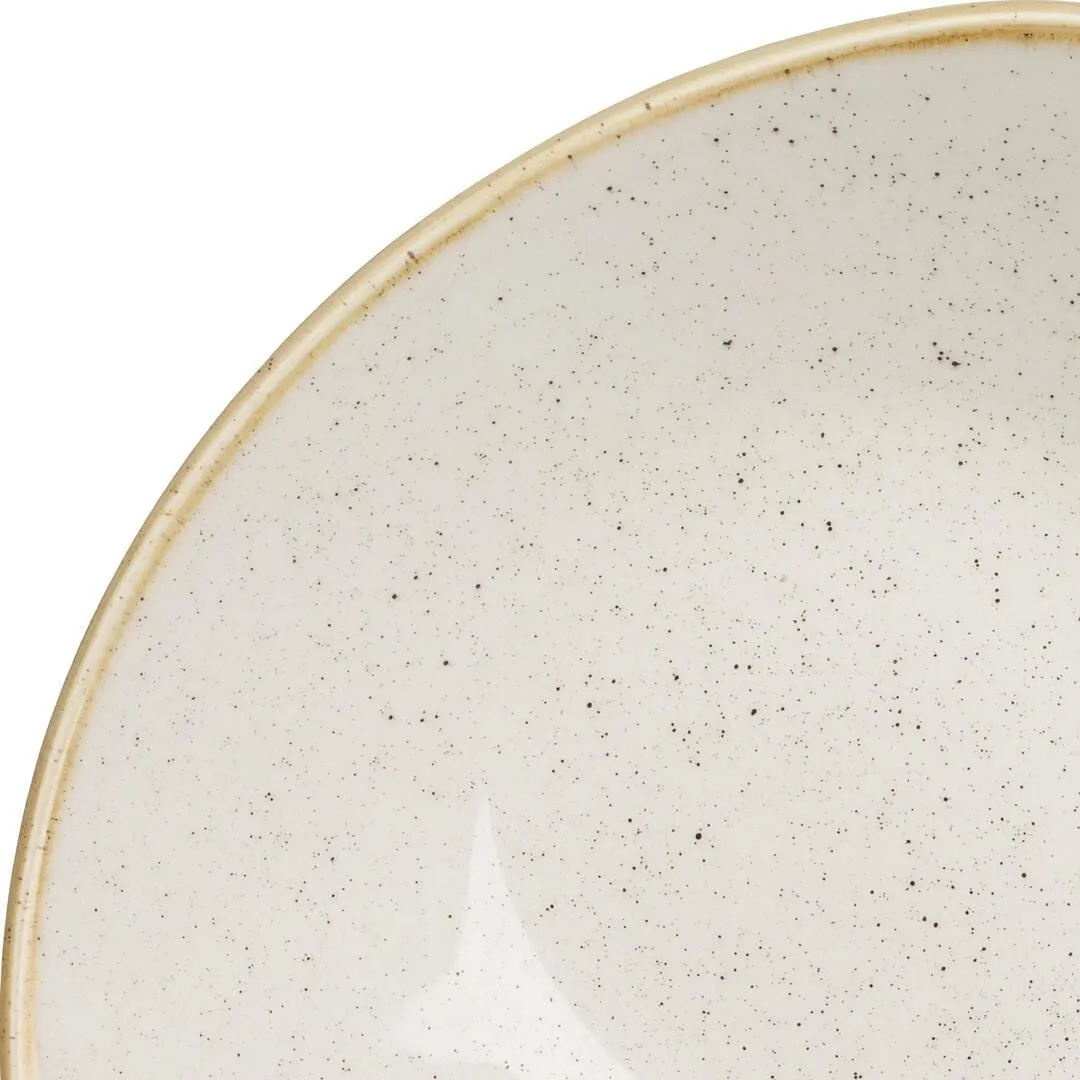 Close-up of the interior of the Churchill Triangular Bowl, showing glossy off-white ceramic with dark speckles and a beige unglazed rim.