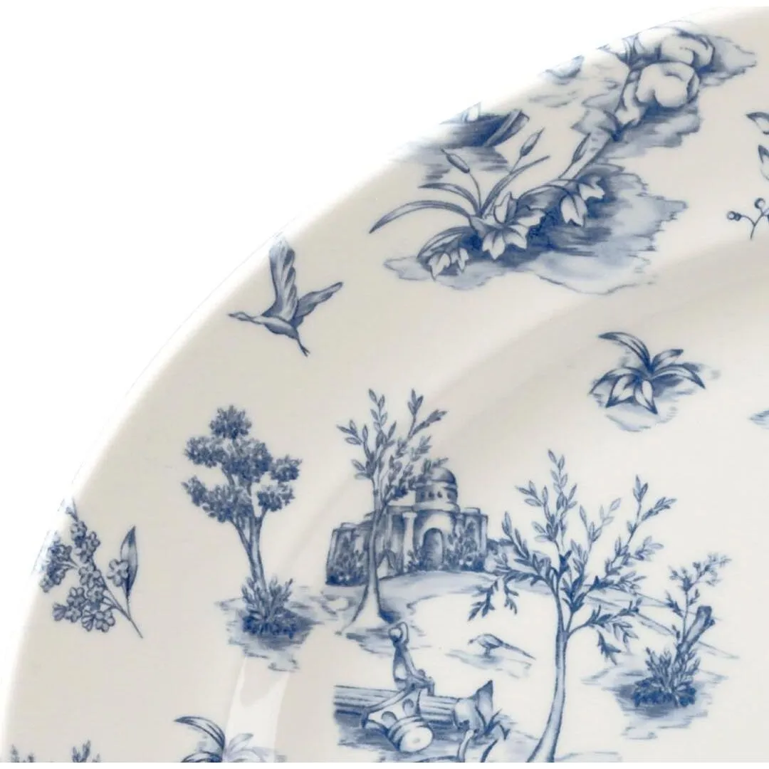 Close-up of the Churchill Oval Wide Rim Plate's curved rim and well, showing the blue Prague Toile pastoral pattern on glossy white ceramic.