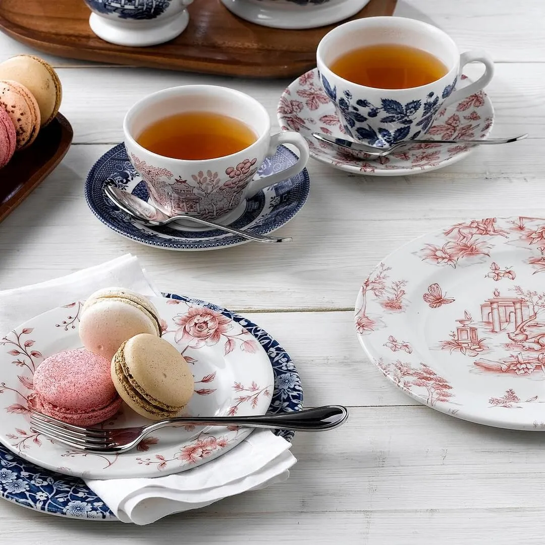 Churchill Prague Toile round plate in use on a table with macarons, a fork, and tea cups